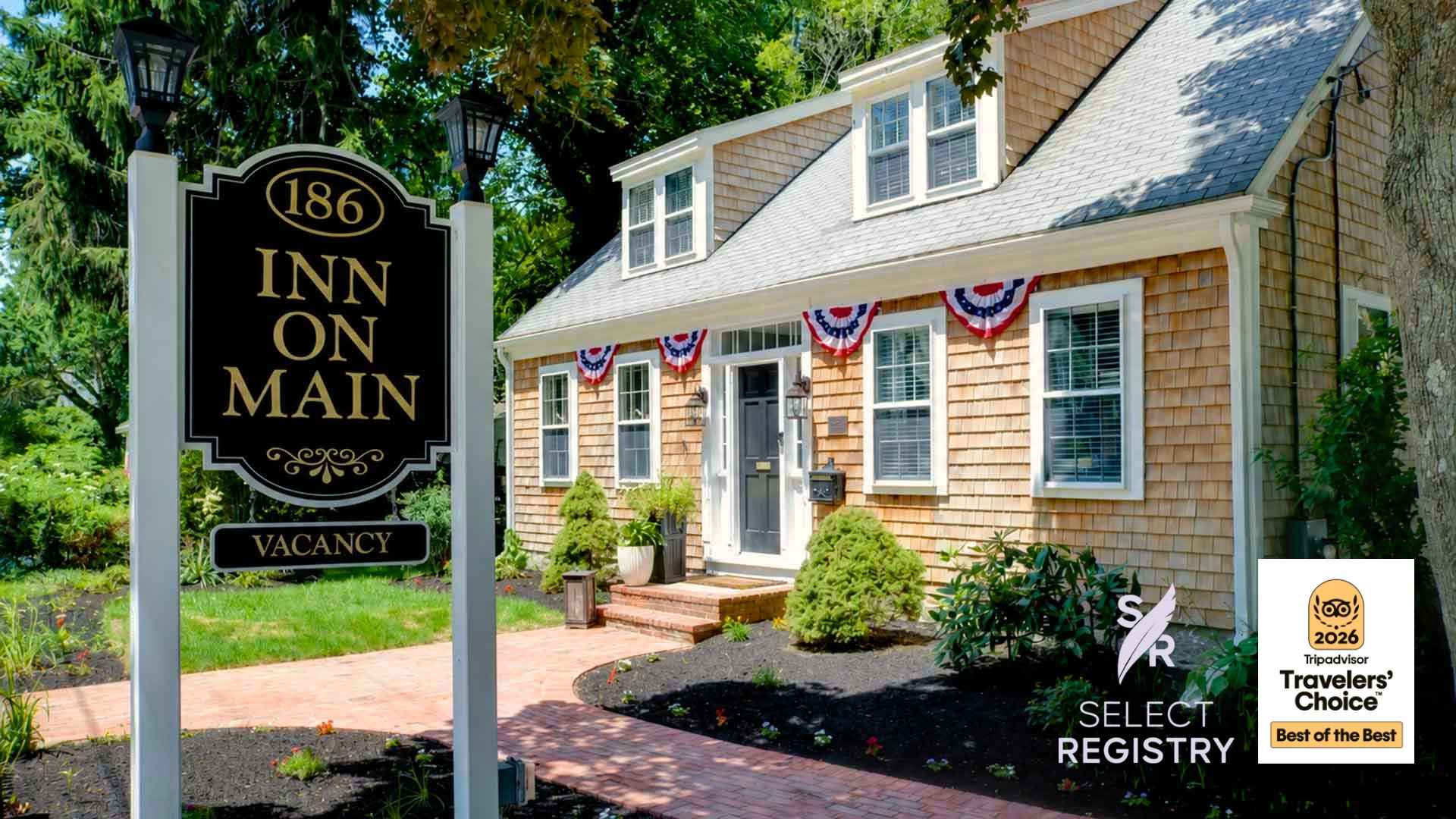 A charming, shingle-style inn with a welcoming sign and decorative bunting.